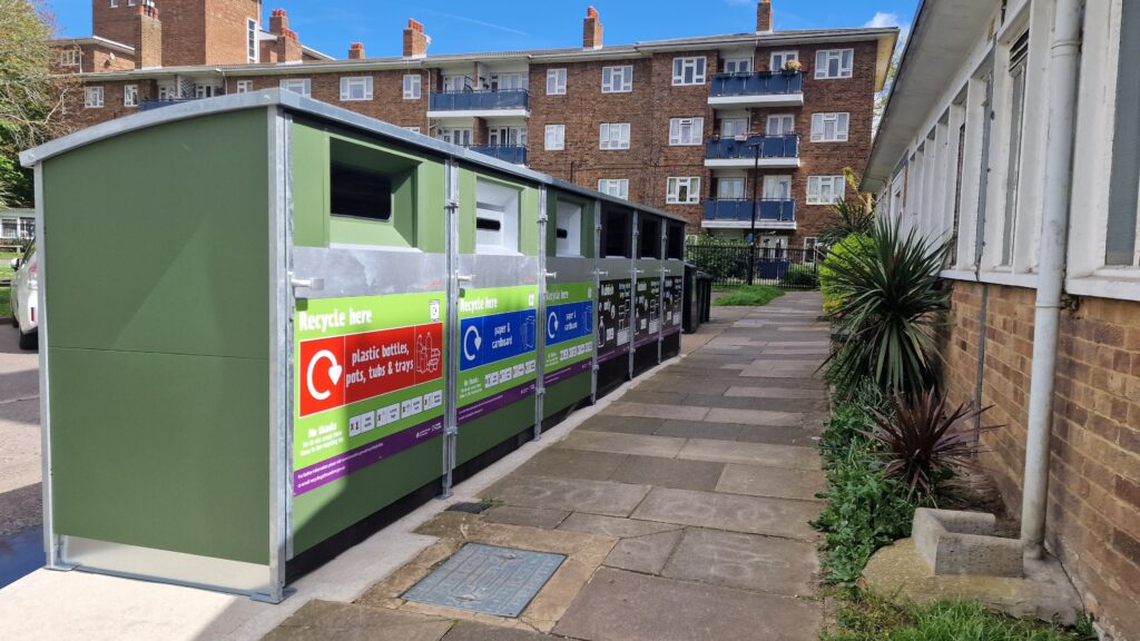 a row of recycling bins on a residential street