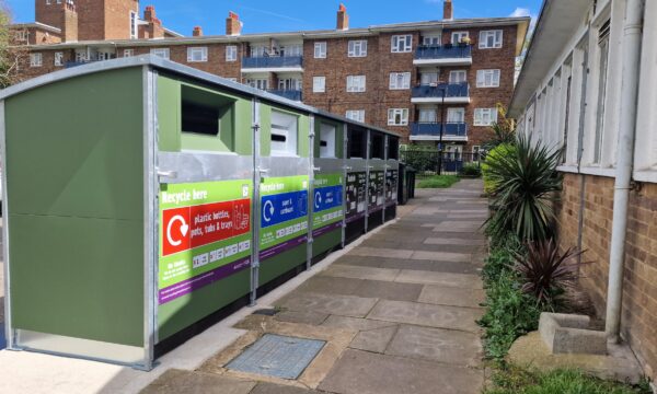 a row of recycling bins on a residential street