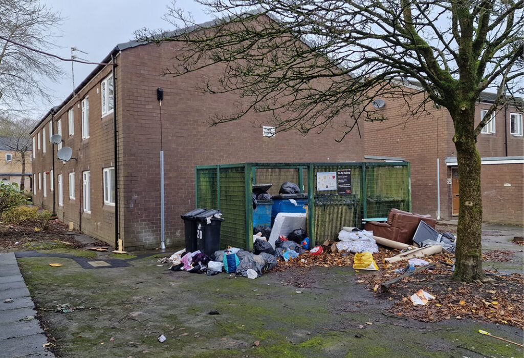 Household waste dumped by bins